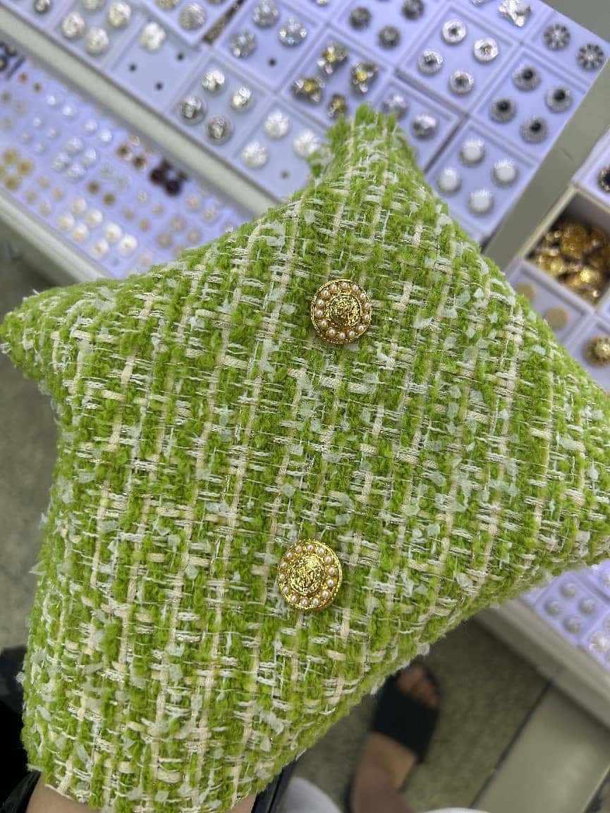 Green tweed with jewel button — fabric developed by Belleza