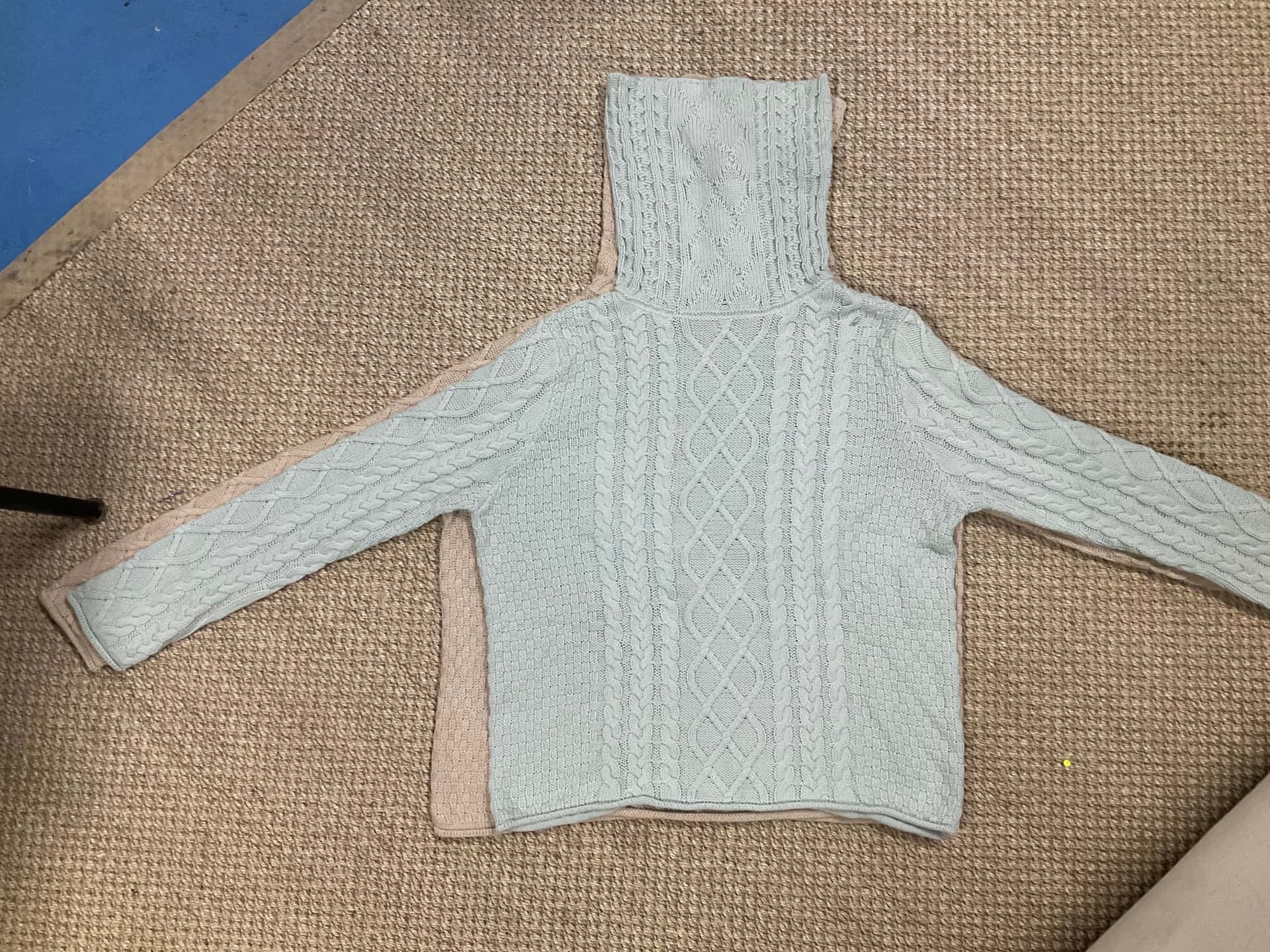 Cable knit, flat on linen — made in the Belleza workshop