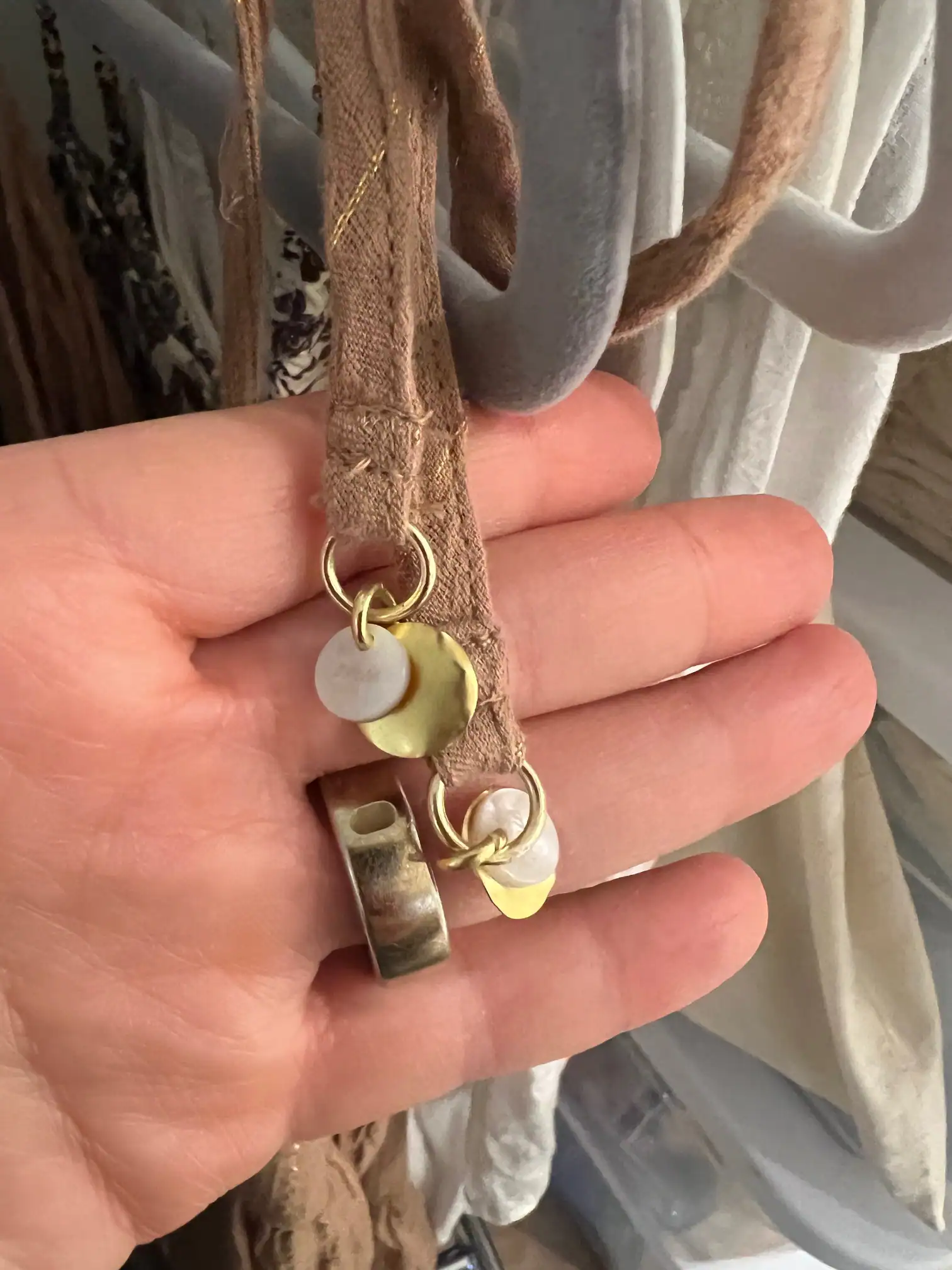 Metal trims and toggles under selection — made in the Belleza workshop